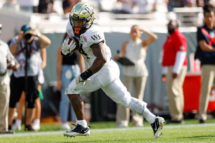 Wake Forest Demon Deacons running back Justice Ellison (14) runs with the ball in the second half against the Rutgers Scarlet Knights at TIAA Bank Field.Nathan Ray Seebeck-USA TODAY Sports